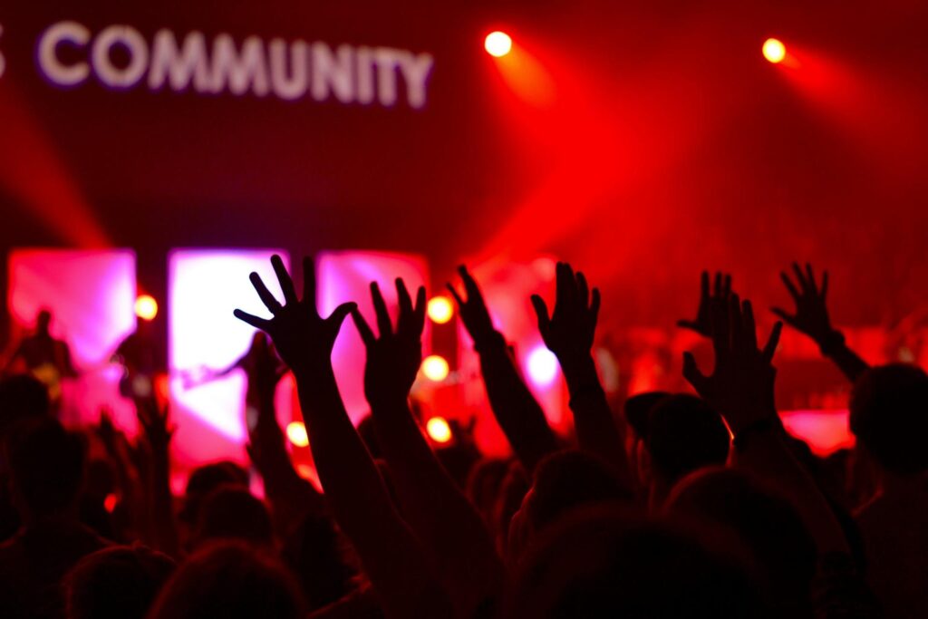 people in church raising their hands in worship